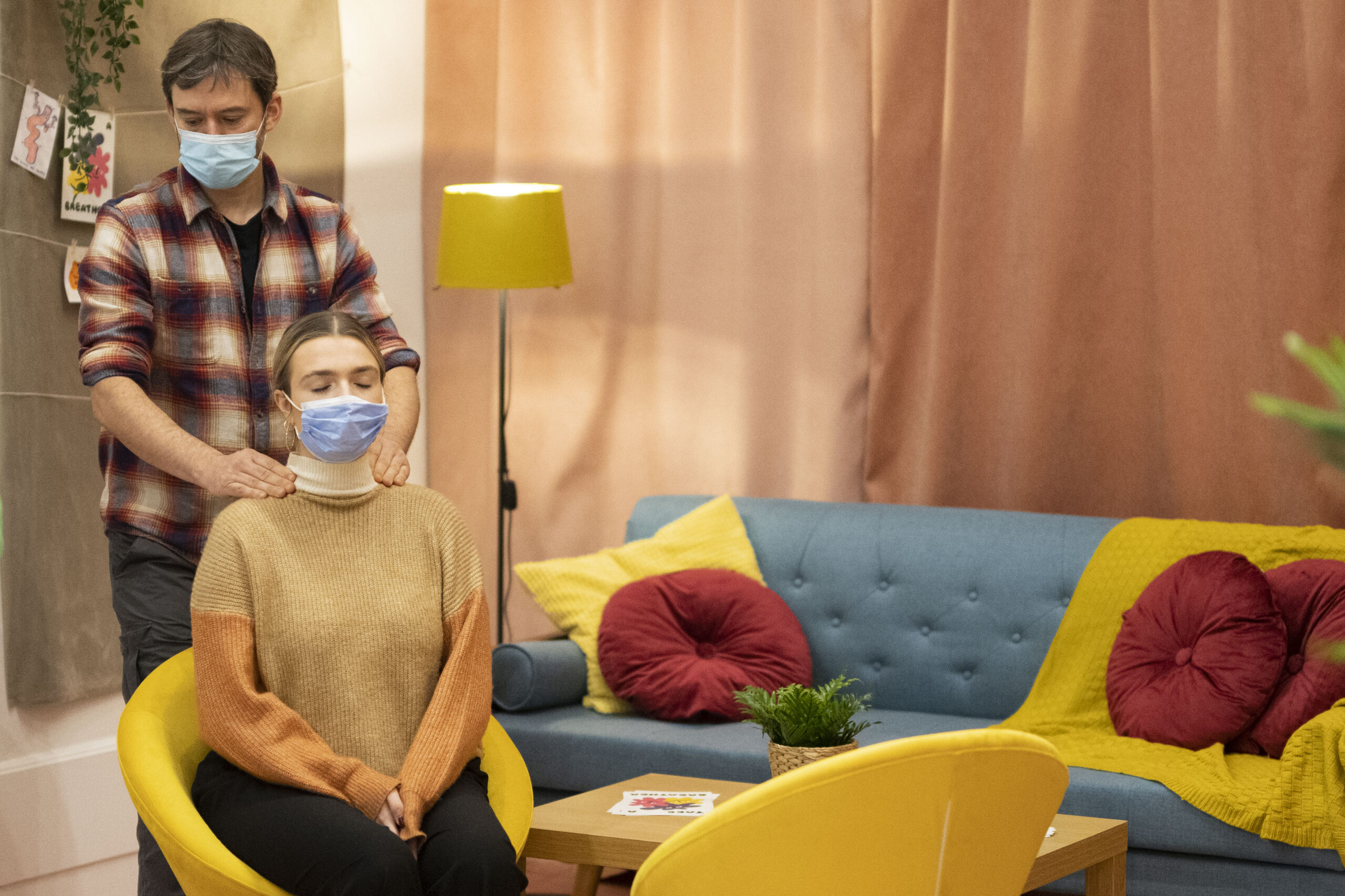 breather bubbles - man giving a shoulder massage a woman wearing a covid-19 face covering